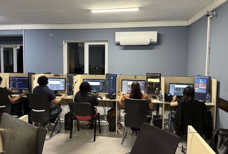 Five DSPro agents at their desks on the call floor